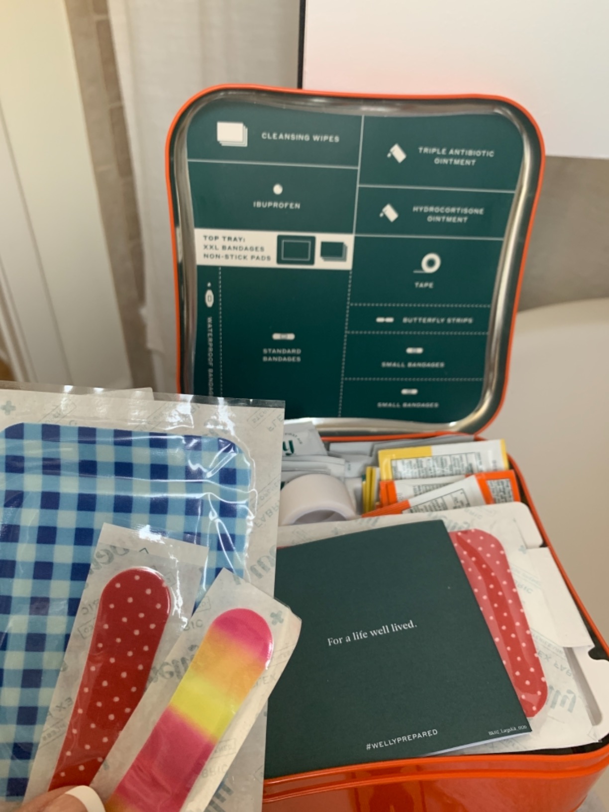 Welly First Aid Kit | FSA Eligible | Adhesive Flexible Fabric and Waterproof Bandages, Tape and Non-Stick Pads, Butterfly Strips, Triple Antibiotic and Hydrocortisone Ointments, Ibuprofen - 130 Count customer photo 1